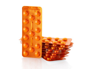 Pile of tablets in blister packaging. Pharmaceutical industry. Pharmacy products. Health care . New blister with pills isolated on a white background.