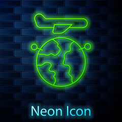 Glowing neon line Globe with flying plane icon isolated on brick wall background. Airplane fly around the planet earth. Aircraft world icon. Vector