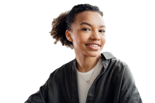 Portrait of a young woman with curly hair looking into the camera. An office employee, a young entrepreneur in the office.