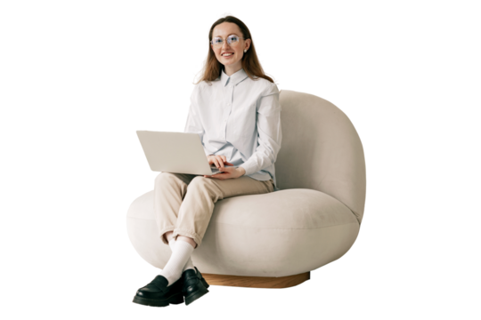 A woman uses a laptop, a stylish designer sits in an armchair. An office employee in glasses and modern clothes.