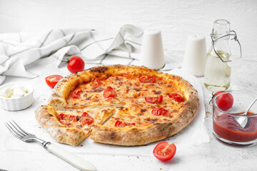 Tasty pizza Margarita with tomatoes and bowl of mozzarella on white table