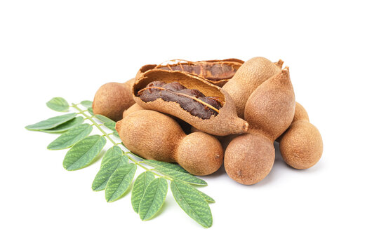 Heap of tasty tamarinds and leaf on white background