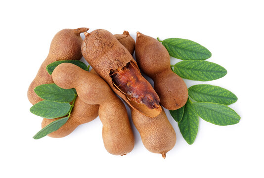Tasty tamarinds and leaves on white background