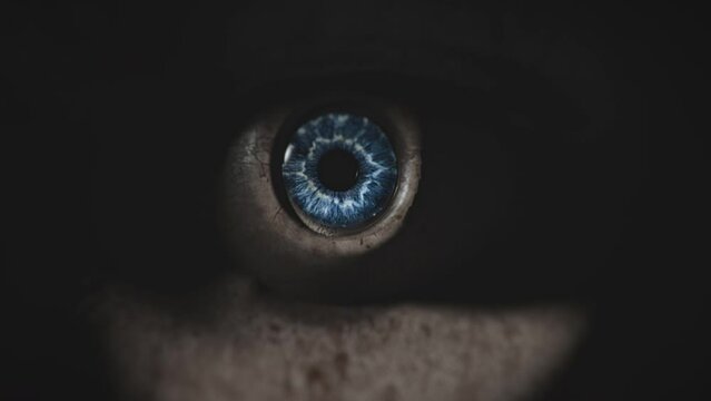 Zoom in into eye of a scary living doll. Damaged android. Cyborg. Artificial intelligence concept. Video transition. High quality cinematic sci-fi, horror, science-fiction video footage. 