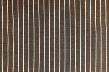 Obraz premium Striped brown white fabric texture background wtih copy space. Shirt fabric, tablecloth textile, garment cloth, upholstery with classic pattern with lines. Backdrop, wallpaper, background.