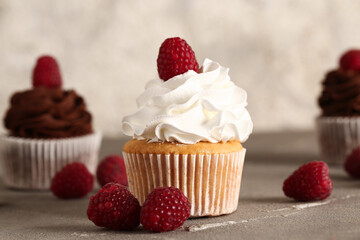 Tasty raspberry cupcake on table