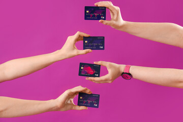 Young women with credit cards on purple background, closeup