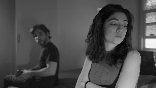 Couple in Crisis/ Woman Dismissing Boyfriend and Refusing to Communicate, Ignoring Him and Crossing Arms in Discontent. Relationship Struggling with Communication Issues in monochromatic