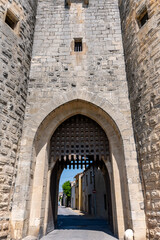 Naklejka premium View on old streets, fort walls and houses in ancient french town Aigues-Mortes, touristic destination with square fortress, Gard, France