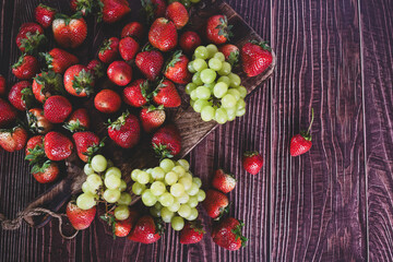ripe freshly harvested organic strawberries and grapes ready to eat.