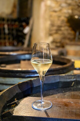 Tasting of grand cru sparkling white wine with bubbles champagne by old champagne caves in grand cru wine producer small village Cramant, Champagne, France