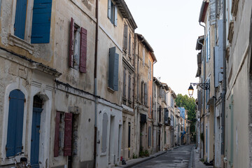 Fototapeta na wymiar View on old streets and houses in ancient french town Arles, touristic destination with Roman ruines, Bouches-du-Rhone, France