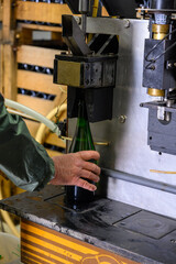 Disgorgement and adding sweet liquor procedure, traditional making champagne sparkling wine from chardonnay and pinor noir grapes in Epernay, Champagne, France