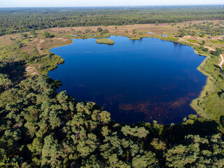 Aerial view on forest and lakes. Sunny morning in Nature protected park area De Malpie near Eindhoven, North Brabant, Netherlands. Nature landscapes in Europe.