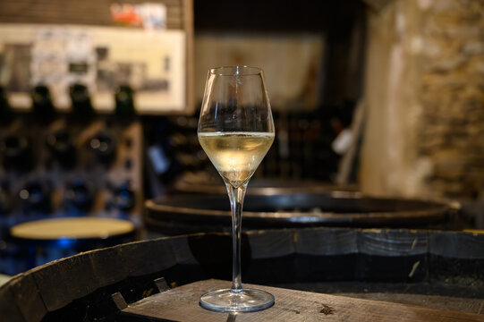 Tasting of grand cru sparkling white wine with bubbles champagne by old champagne caves in grand cru wine producer small village Cramant, Champagne, France