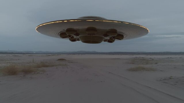 Giant flying saucer landing in the desert. UFO, UAP. High quality cinematic sci-fi film video footage. Alien spaceship. Vintage science-fiction. Alien invasion concept. Part 3 of 3. 