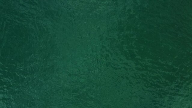 image  from above of a gren and calm sea