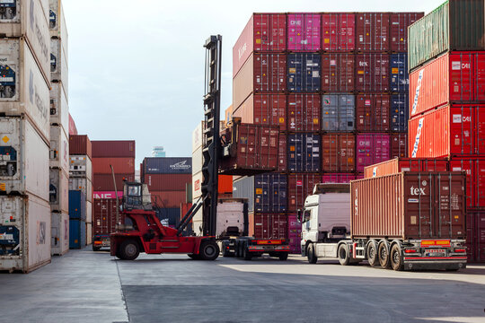 Istanbul, Beylikduzu - Turkey - 07.07.2023 Container yard for Logistic Import Export business, colorful container stack. view from moment of load. crane hold a container