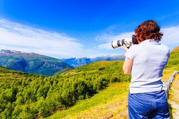 Fototapeta na wymiar Tourist taking photo in norwegian nature