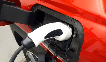 EV car or electric car at charging station with power bank connected. Eco friendly alternative energy concept