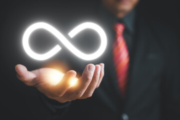 Circular infinity symbol on dark background, symbolizing circular economy and infinite possibilities. Strategy of sustainable investment, banking, and financial growth. technology infinity data