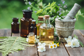 Assortment of pure organic natural essential aroma oil with mint , camomile on wooden background....
