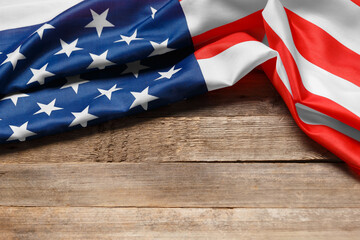 American flag on a rustic wooden background, copy space. Symbol of independence, patriotism.