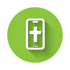 White Christian cross on mobile phone icon isolated with long shadow background. Church cross. Green circle button. Vector