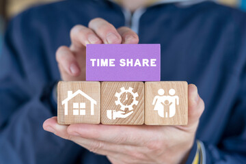 Man holding colorful blocks and sees inscription: TIME SHARE. Concept of time share. Timeshare. Time to share.