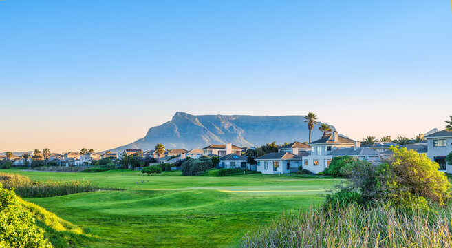 Panorama shot golf course and the table muntain in the background during sunset, Cape Town, South Africa
