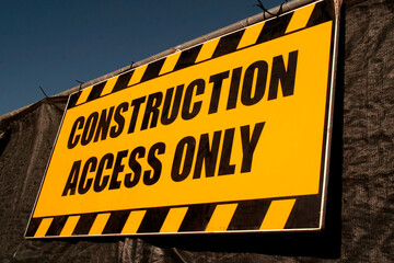 Bright yellow sign with black capitalletters stating Construction Access Only