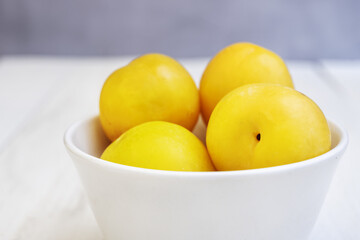 A white porcelain bowl filled with ripe