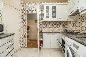 An old kitchen with white furniture