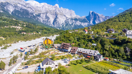 Aerial drone view of the rustic homes and hotels of Theth National Park, Albania. Albanian Alps