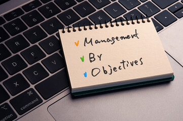 There is notebook with the word Management by Objectives. It is as an eye-catching image.