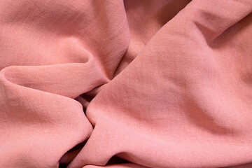 background and texture of pink cotton fabric with folds