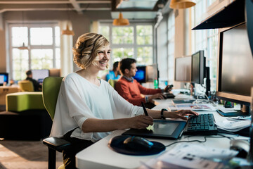 Young Caucasian woman using the computer in a startup company office