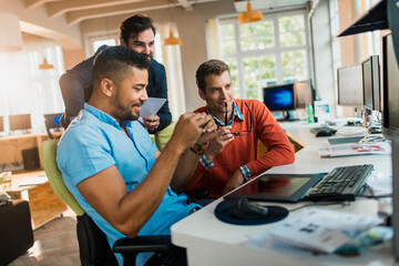 Young and diverse group of people working together in a startup company office