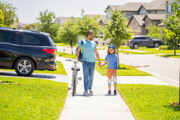 father and son outdoor. father and son enjoying a bicycle ride together. active son and father duo cycling on bicycle. fathers guidance and support. father teaching his son to ride a bicycle