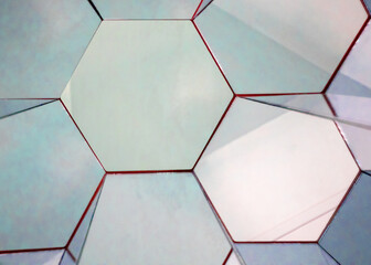 view of a kaleidoscope of mirrors in the form of regular hexagons of silver color