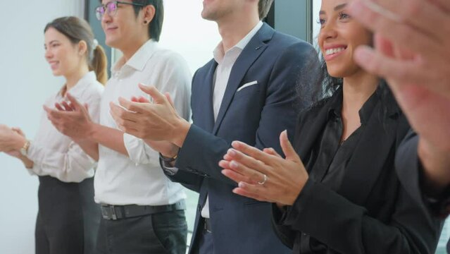 Close up hand of young businessman and businesswoman clapping together. 