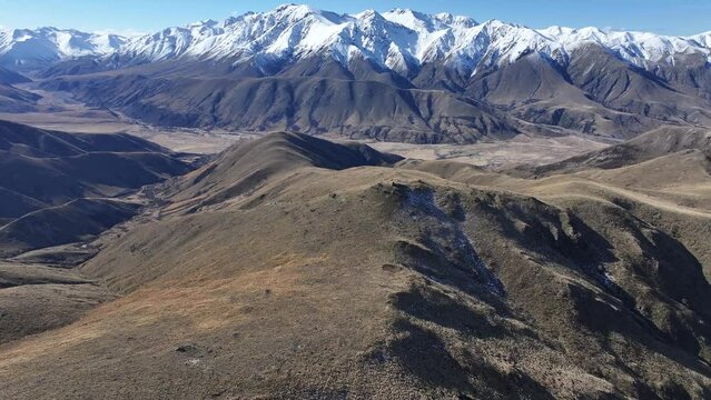 Beautiful winter day above Mount Barossa, aerial view of majestic snowy mountain range and valley. New Zealand