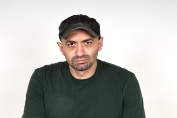 Portrait of a handsome rugged young man wearing a black military cap.