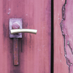 closeup on old handle on wooden door