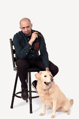 portrait of a cigar aficionado and his best friend, a dog is man's best friend - 644295607