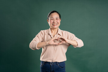 Gangang middle-aged Asian female portrait posing on blue background