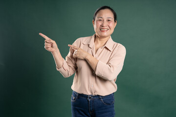 Gangang middle-aged Asian female portrait posing on blue background