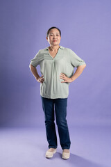 Gangang middle-aged Asian female portrait posing on purple background