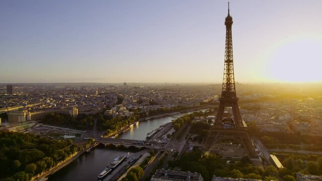 Beautiful aerial view of famous Eiffel Tower in France with colorful romantic sky at twilight. Cinematic 4k.