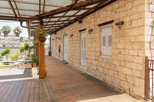 An old  stone house with wooden windows on one of the quiet streets near the main pedestrian HaMeyasdim in Zikhron Yaakov city in northern Israel